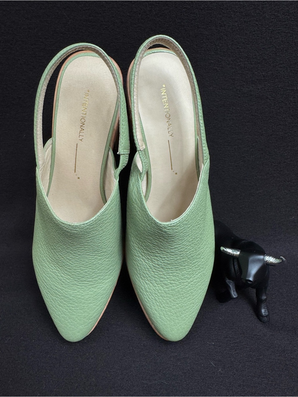 sage green leather slingback mules by Intentionally Blank.